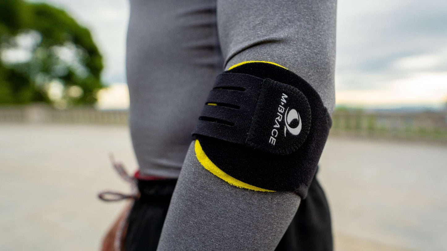 M-Brace Epicondylitis Brace worn on arm for support and pain reduction.