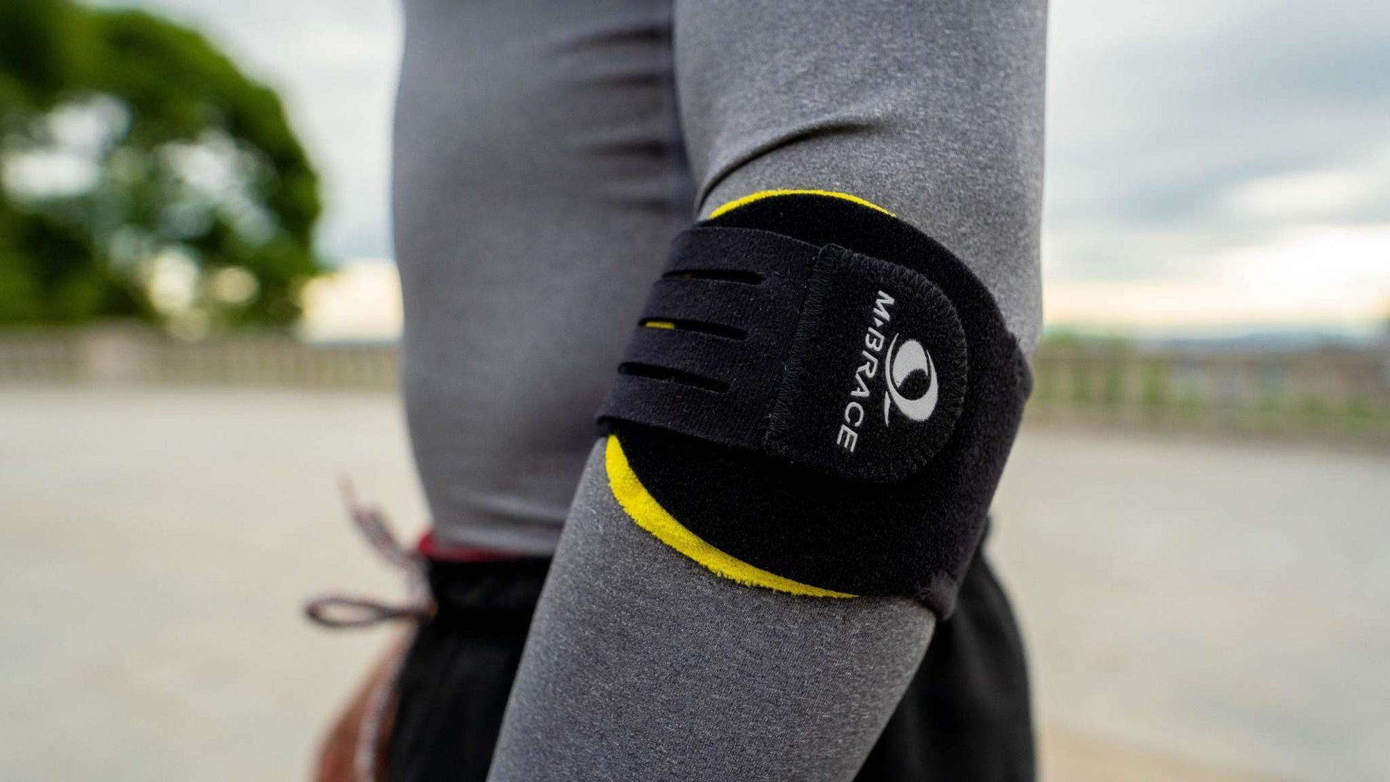 M-Brace Epicondylitis Brace worn on arm for support and pain reduction.