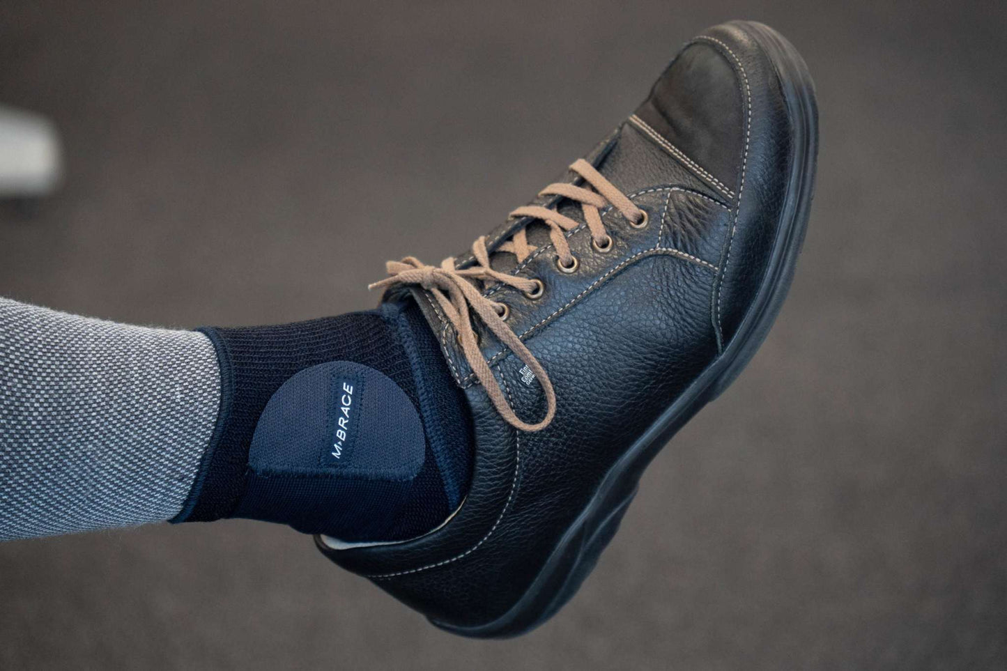 M-Brace Strenua Extra Ankle Lock worn with a shoe, showcasing the comfortable, breathable design.