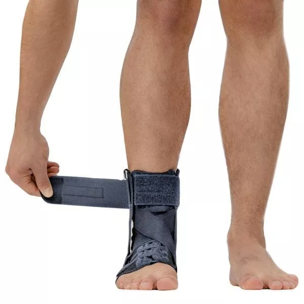 M-Brace Salto Ankle Stabilizer being applied, showcasing its easy-to-use design and secure fit.